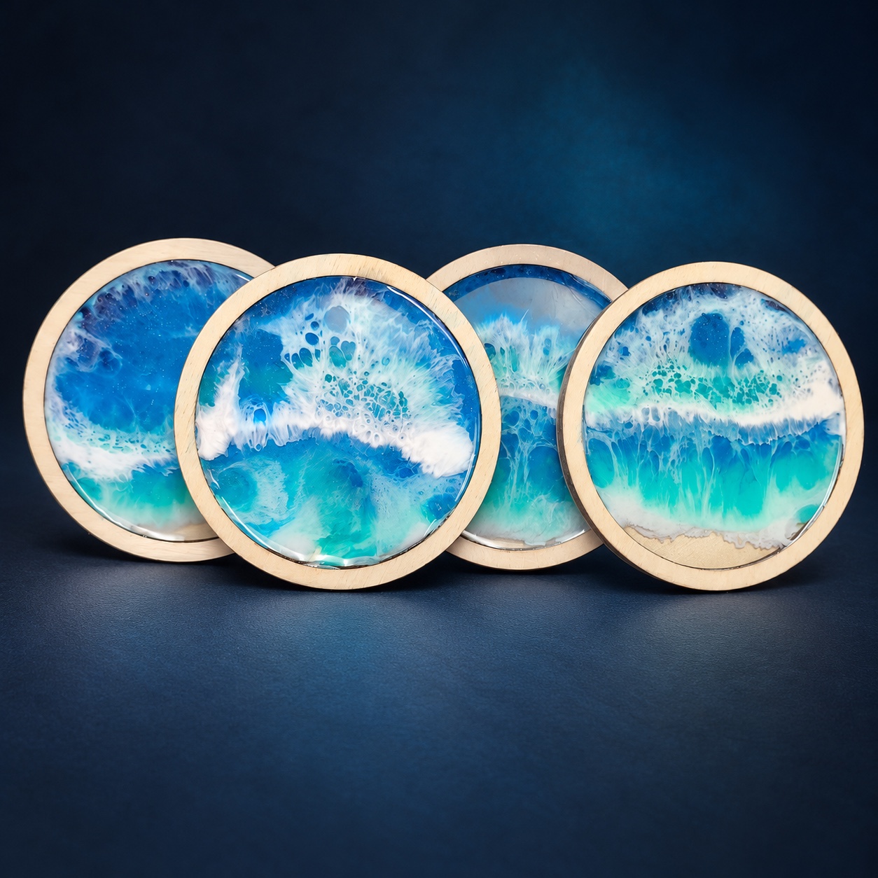 Four round coasters with turquoise ocean-wave resin artwork