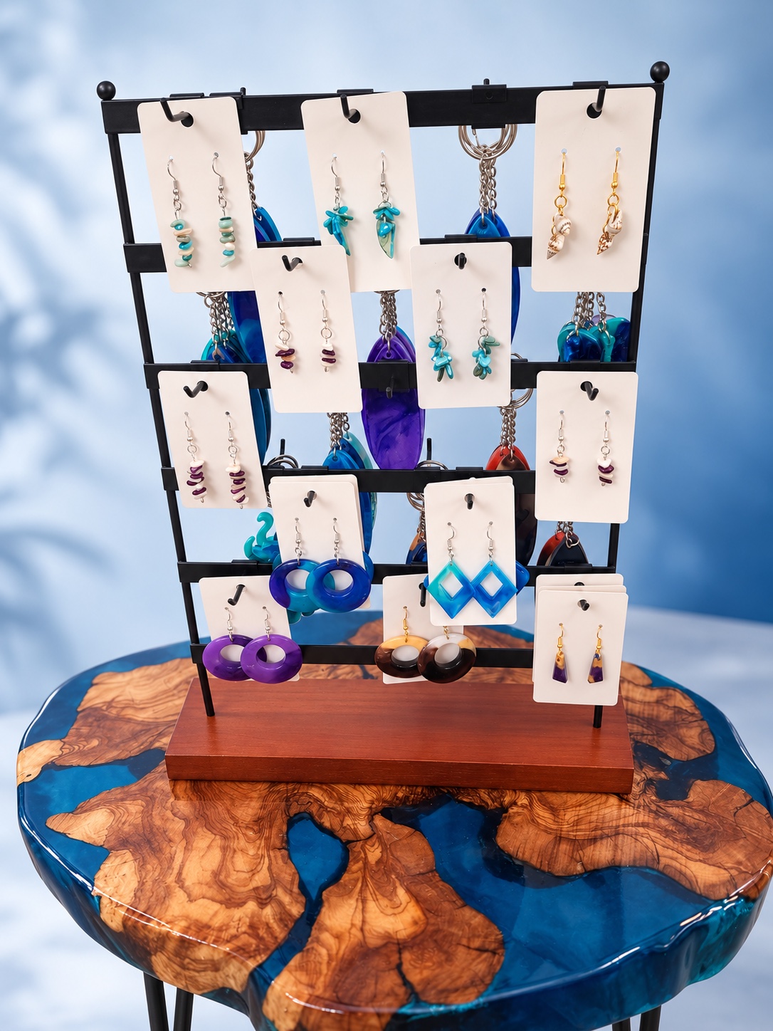 Display of handmade turquoise, cobalt, purple, and shell earrings