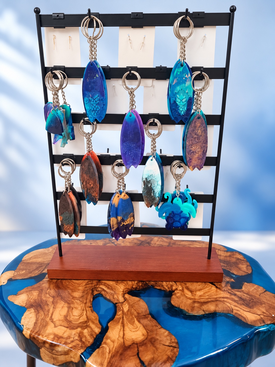 Display of handmade turquoise, cobalt, and purple resin keychains