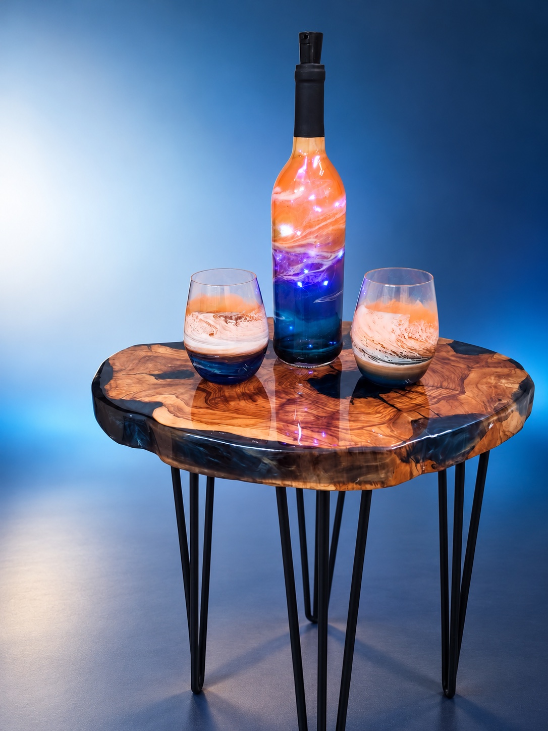 Illuminated coral and cobalt resin bottle with two coordinating glasses