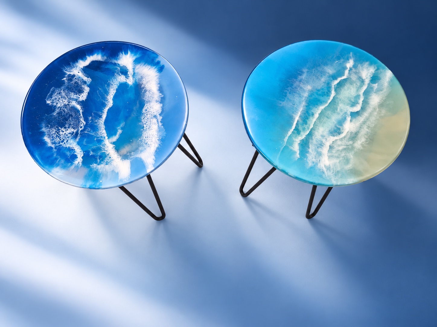 Pair of round blue and white ocean-wave resin side tables
